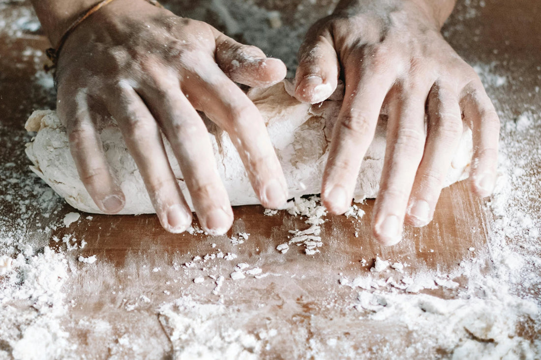 A person kneading dough